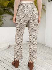 Geometric print drawstring cuff trousers in beige with black pattern, cropped length.