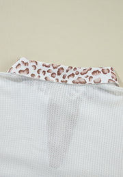 White waffle knit polo with leopard print collar detail