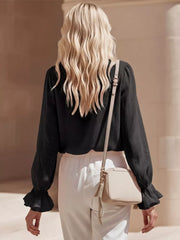 Black maternity shirt with ruffled cuffs and V-neck detail.