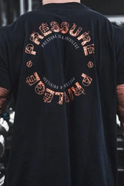Black graphic t-shirt with circular "Pressure Is A Privilege" text and distressed font detail.