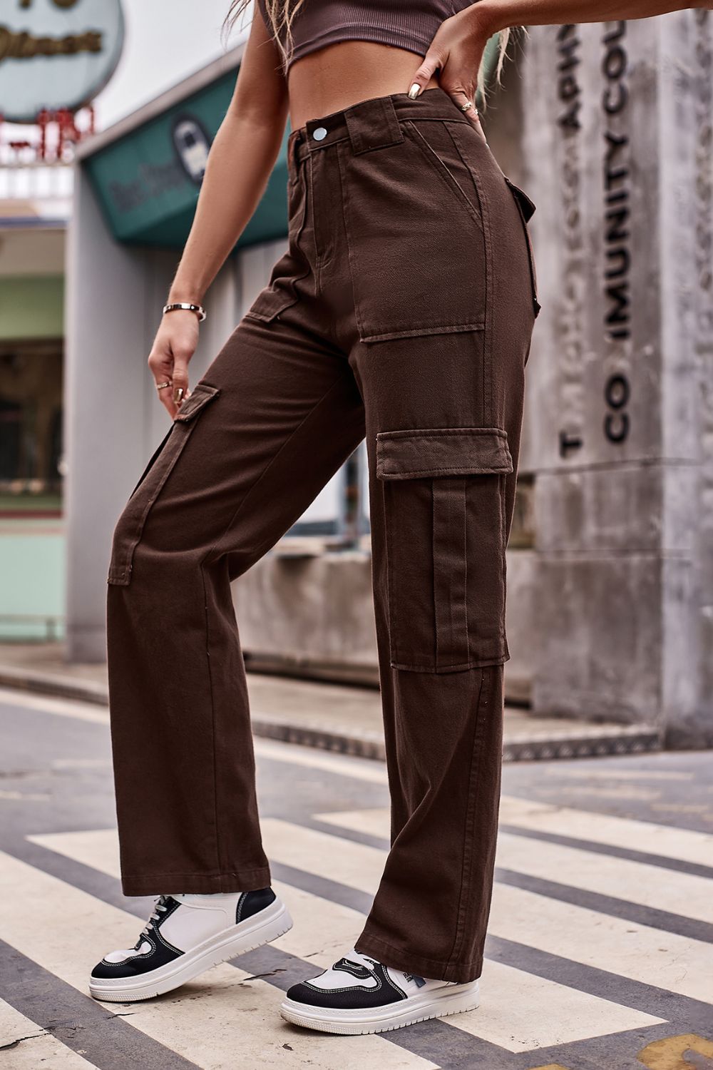 Brown utility pocket wide leg cargo pants with multiple flap pockets.
