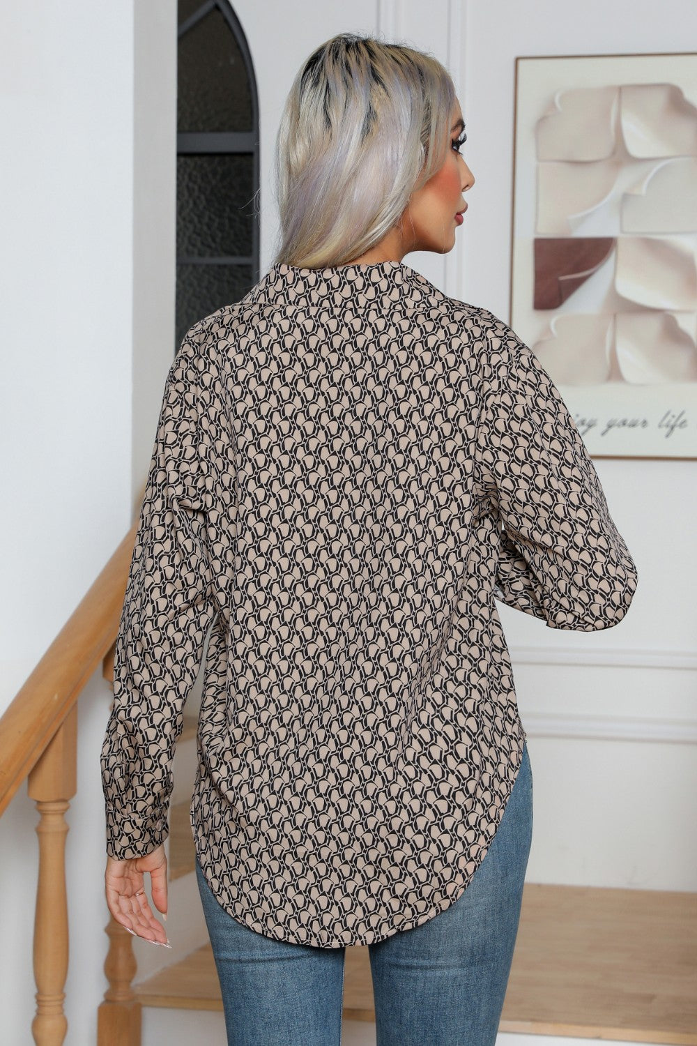 Khaki collared blouse with allover monogram print, button front, and long sleeves.
