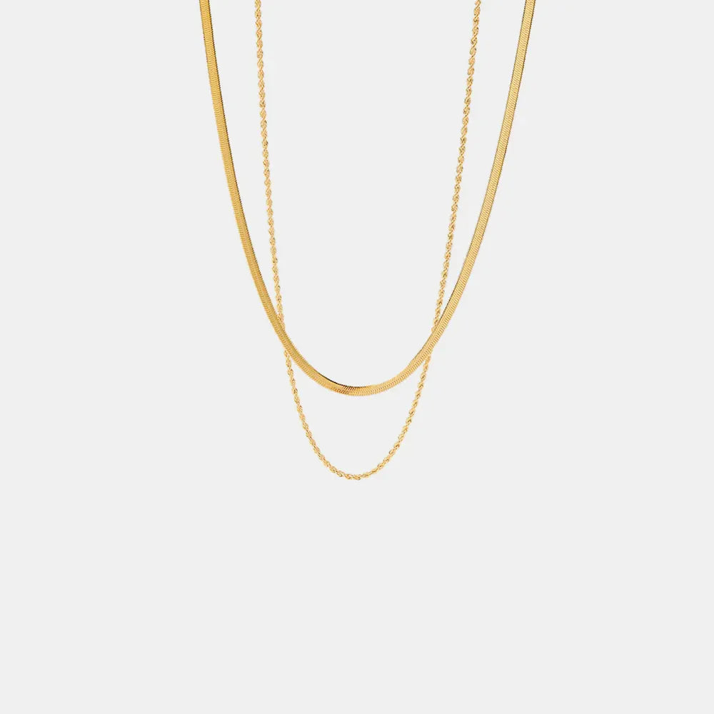 Gold serpentine and rope chain necklaces layered