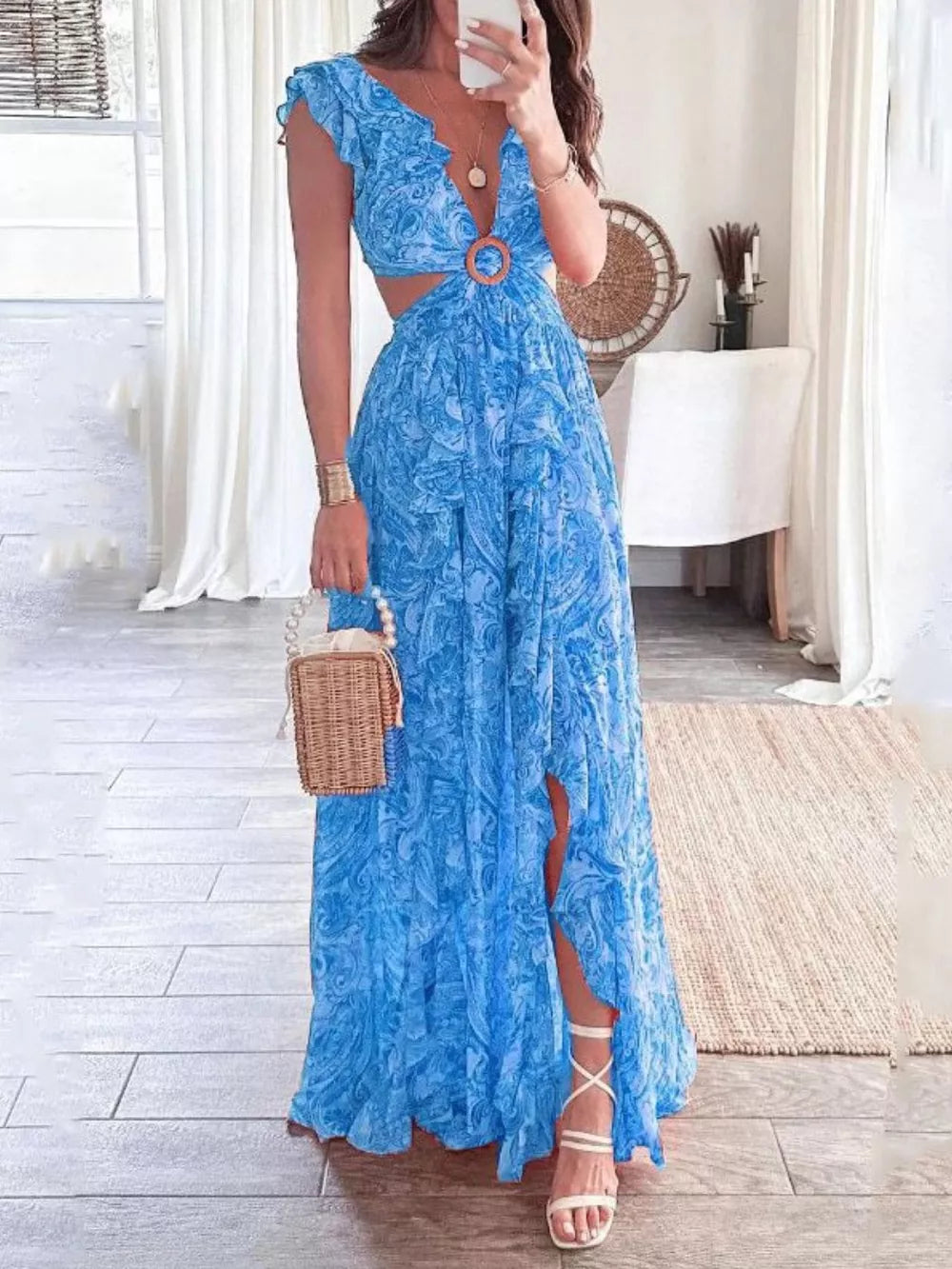 Sky blue ruffled V-neck maxi dress with cut-outs and a wood ring detail.