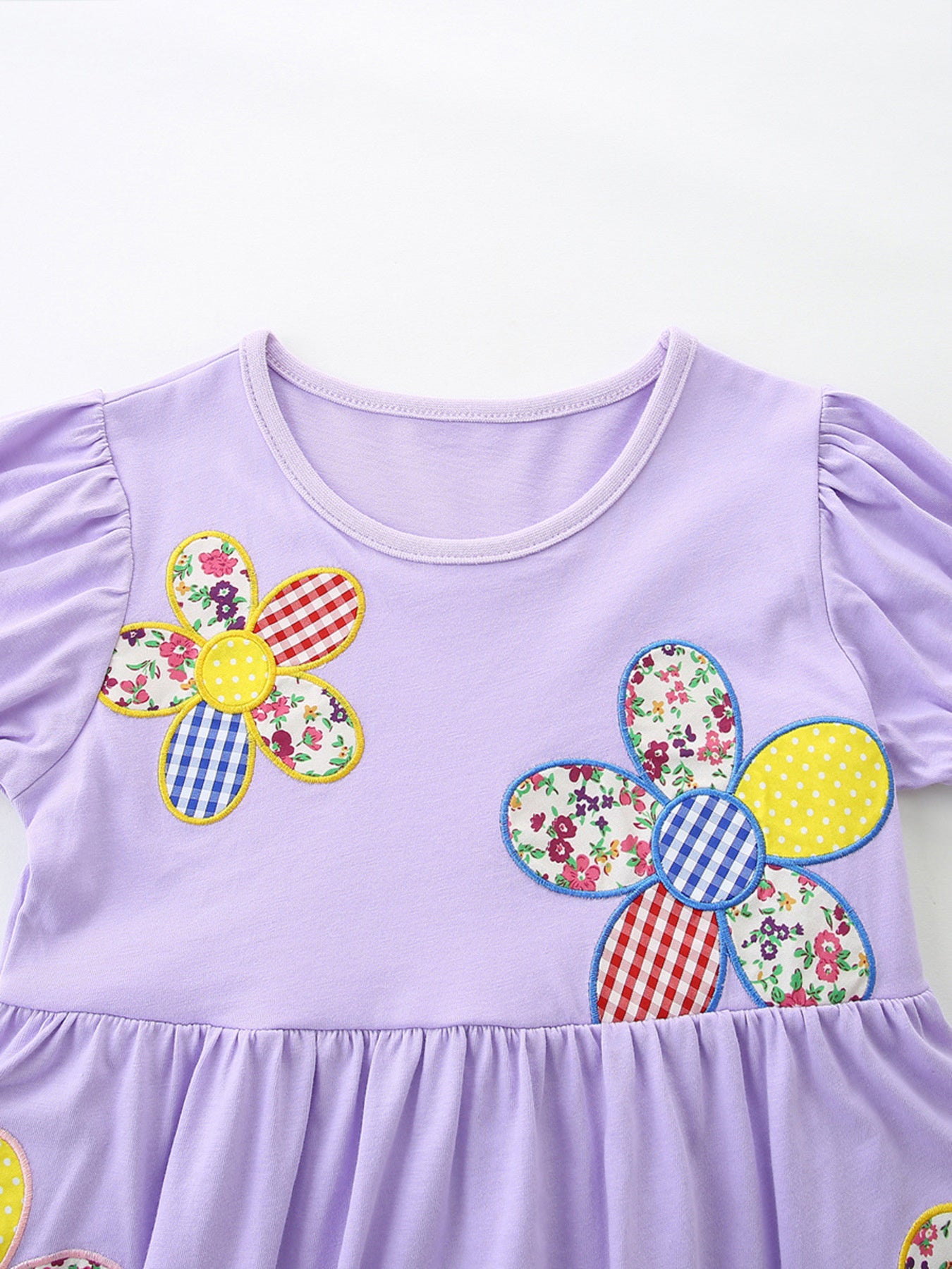 Lavender cotton toddler dress with whimsical floral appliqué and ruffled hem.