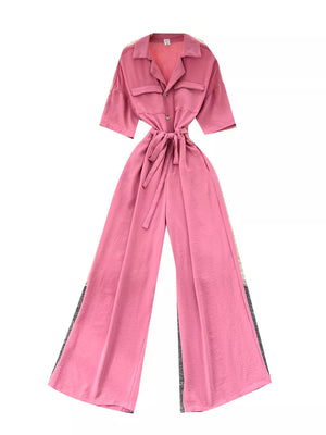Pink belted wide-leg maternity jumpsuit with pockets and buttoned front.