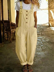Yellow linen-blend wide leg romper with button front and large pockets.