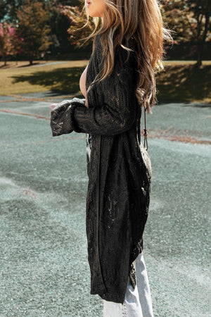 Black openwork maxi cardigan with a textured knit and long sleeves.