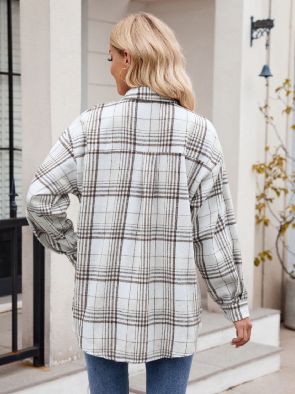 Oversized plaid shirt jacket in white with brown checks, long sleeves, and buttoned front.