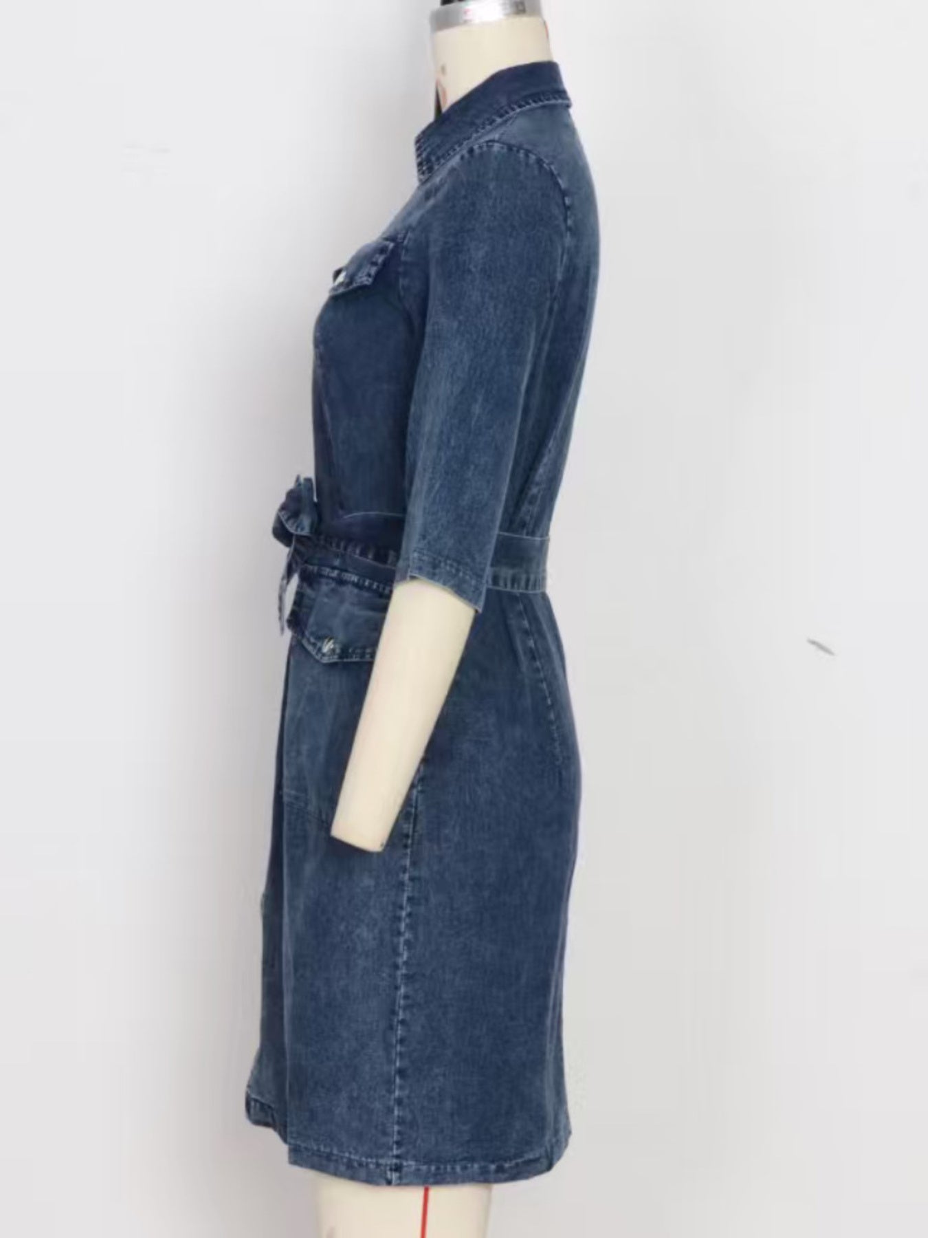 Denim shirt dress in blue with a zipper front, belted waist, and elbow-length sleeves.