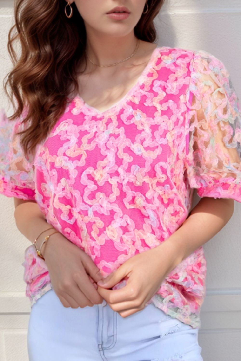Fuchsia pink floral appliqué mesh sleeve blouse with V-neck.