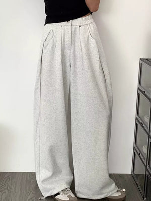 Men's gray wide-leg sweatpants with adjustable drawstring hem and pockets.