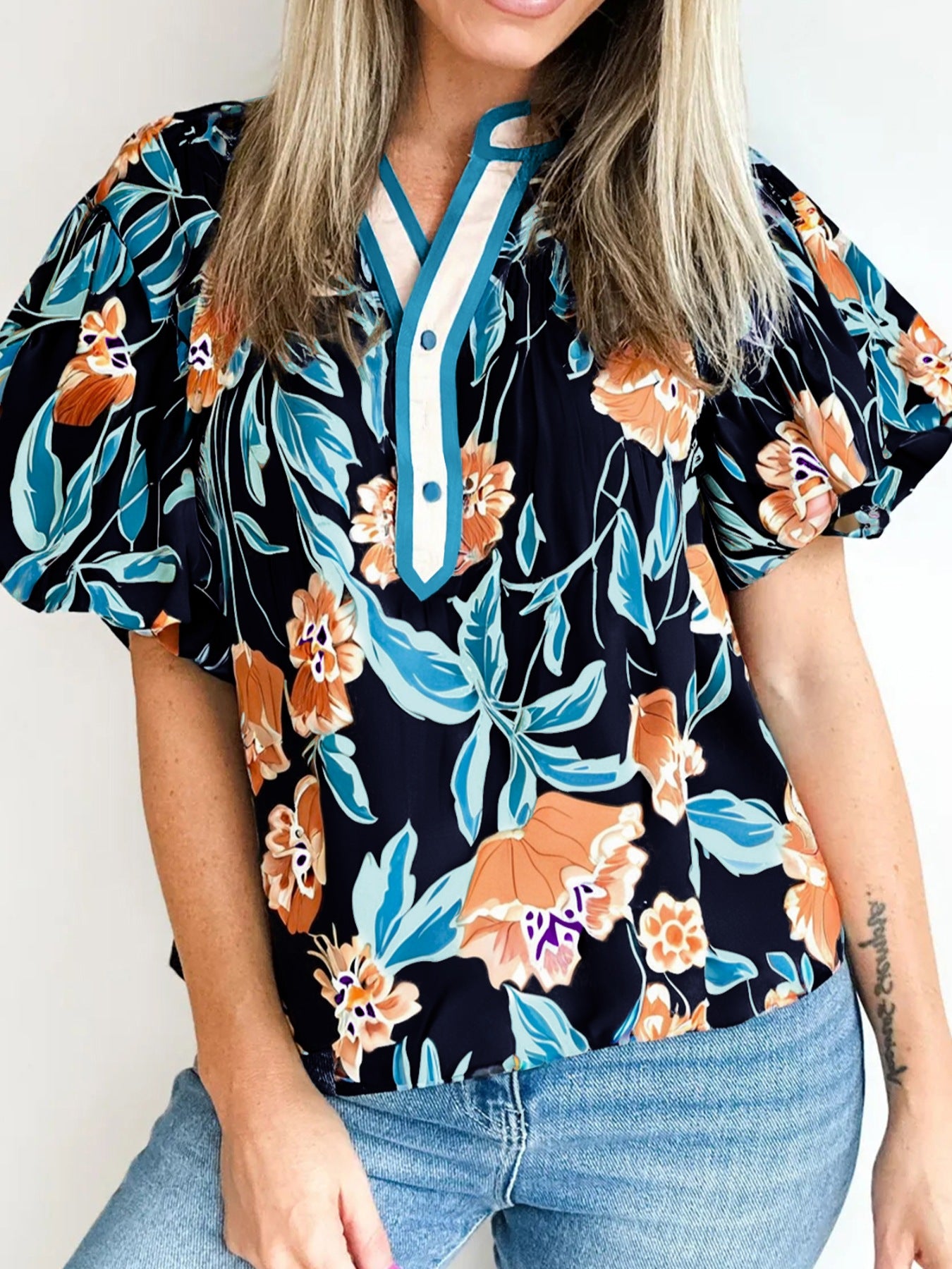 Bubble sleeve buttoned blouse with orange and blue floral print and contrast trim neckline