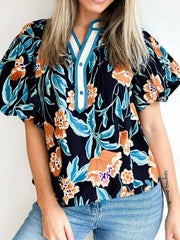 Bubble sleeve buttoned blouse with orange and blue floral print and contrast trim neckline