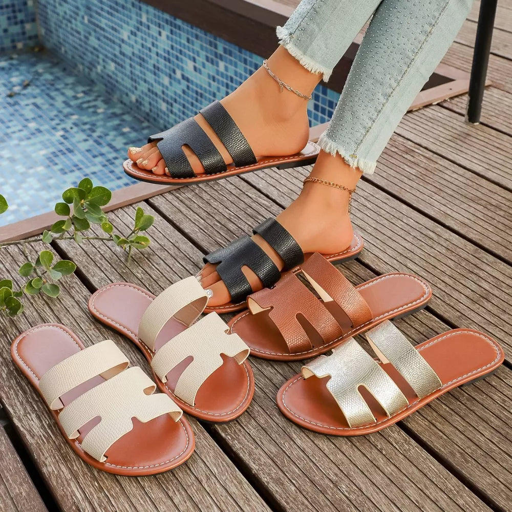 Chic two-strap open-toe sandals in black, brown, gold, and beige with textured straps.