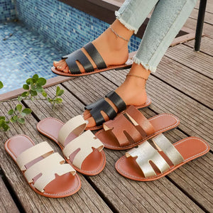 Chic two-strap open-toe sandals in black, brown, gold, and beige with textured straps.