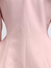 Pink skirt suit with balloon sleeves and a frill collar detail.
