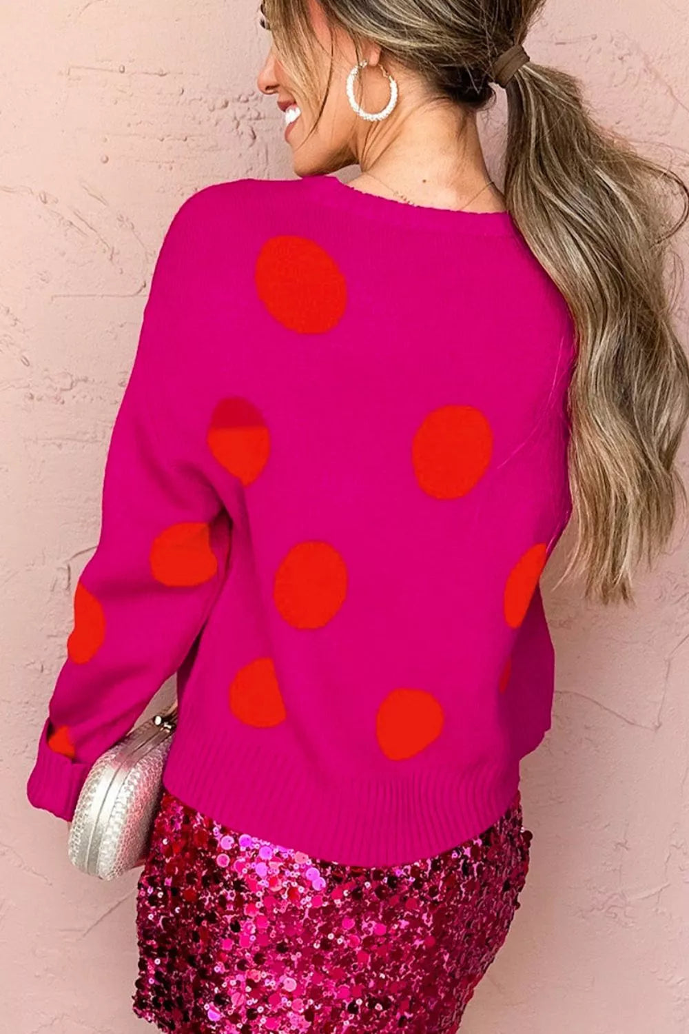 orange pullover sweater featuring ribbed and polka dot