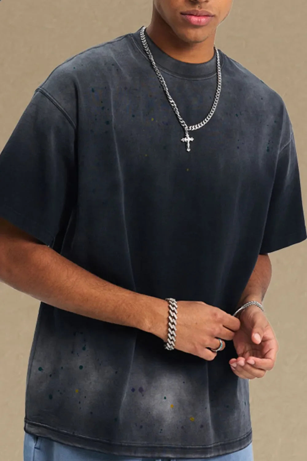 Oversized black t-shirt with paint splatter detail and crew neck.