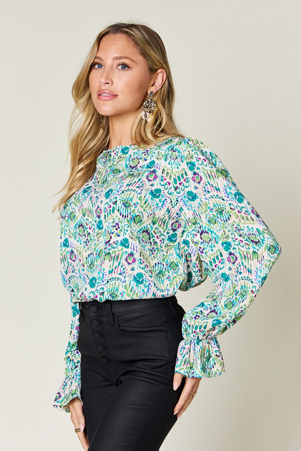 Painterly print blouse in sky blue with gathered long sleeves and a mock neckline.