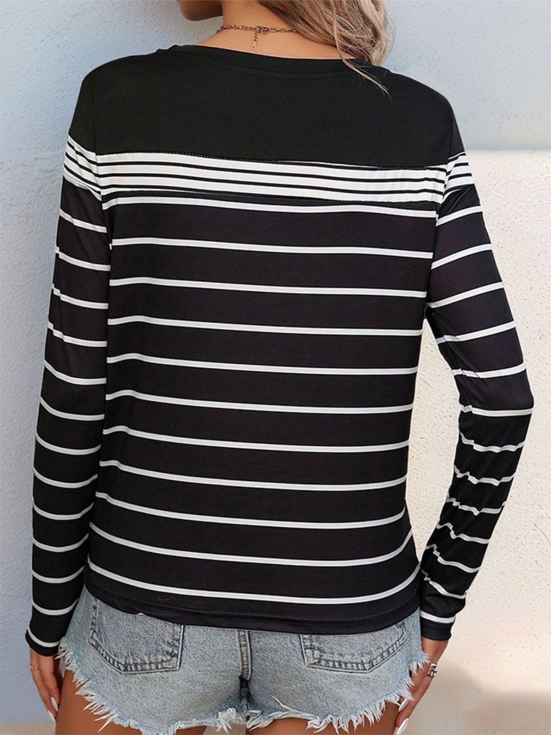 Black crew neck tee with white horizontal stripes and long sleeves