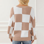 Checkerboard knit drop shoulder pullover sweater in tan and white acrylic with a crew neck.