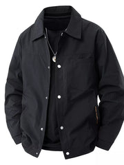 Black snap-down jacket with subtle vertical stripe texture and chest pocket.