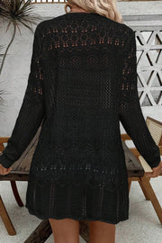 Black openwork crochet duster cardigan with long sleeves and intricate patterns.