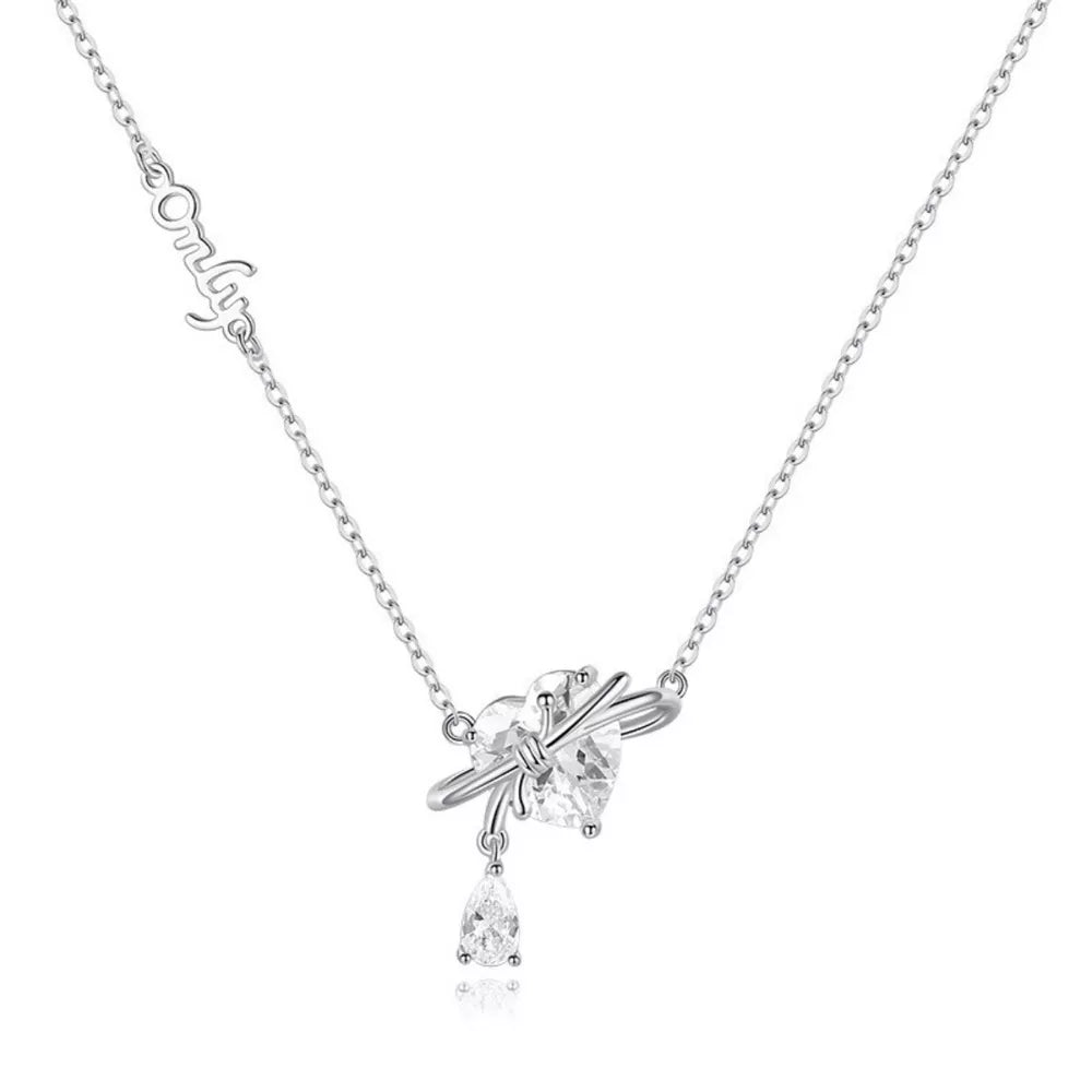 Silver necklace with a heart-shaped zircon pendant and a dangling pear-shaped zircon.