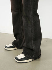 Dark wash denim jeans with a faded, distressed look and a flare cut.