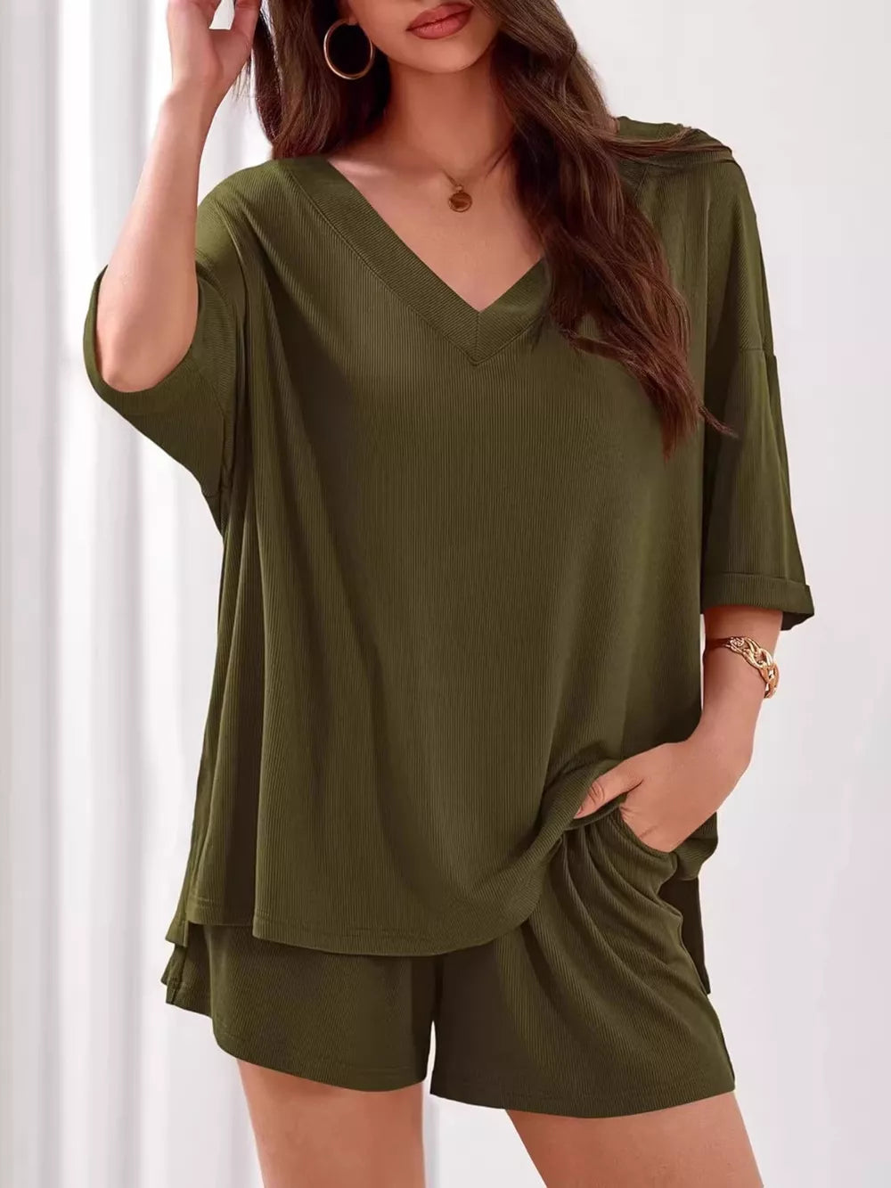 Sage green ribbed V-neck two-piece loungewear set with cuffed sleeves and shorts.