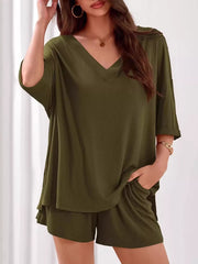 Sage green ribbed V-neck two-piece loungewear set with cuffed sleeves and shorts.