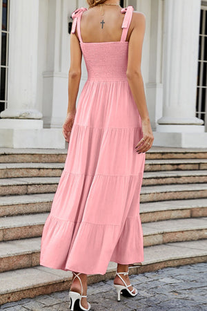 Blush pink tiered ruffle maxi dress with smocked bodice and tie straps.