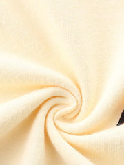 Cream cotton t-shirt fabric detail with a hint of a colorful racing car graphic.
