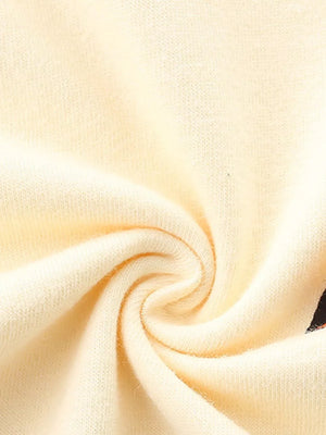 Cream cotton t-shirt fabric detail with a hint of a colorful racing car graphic.