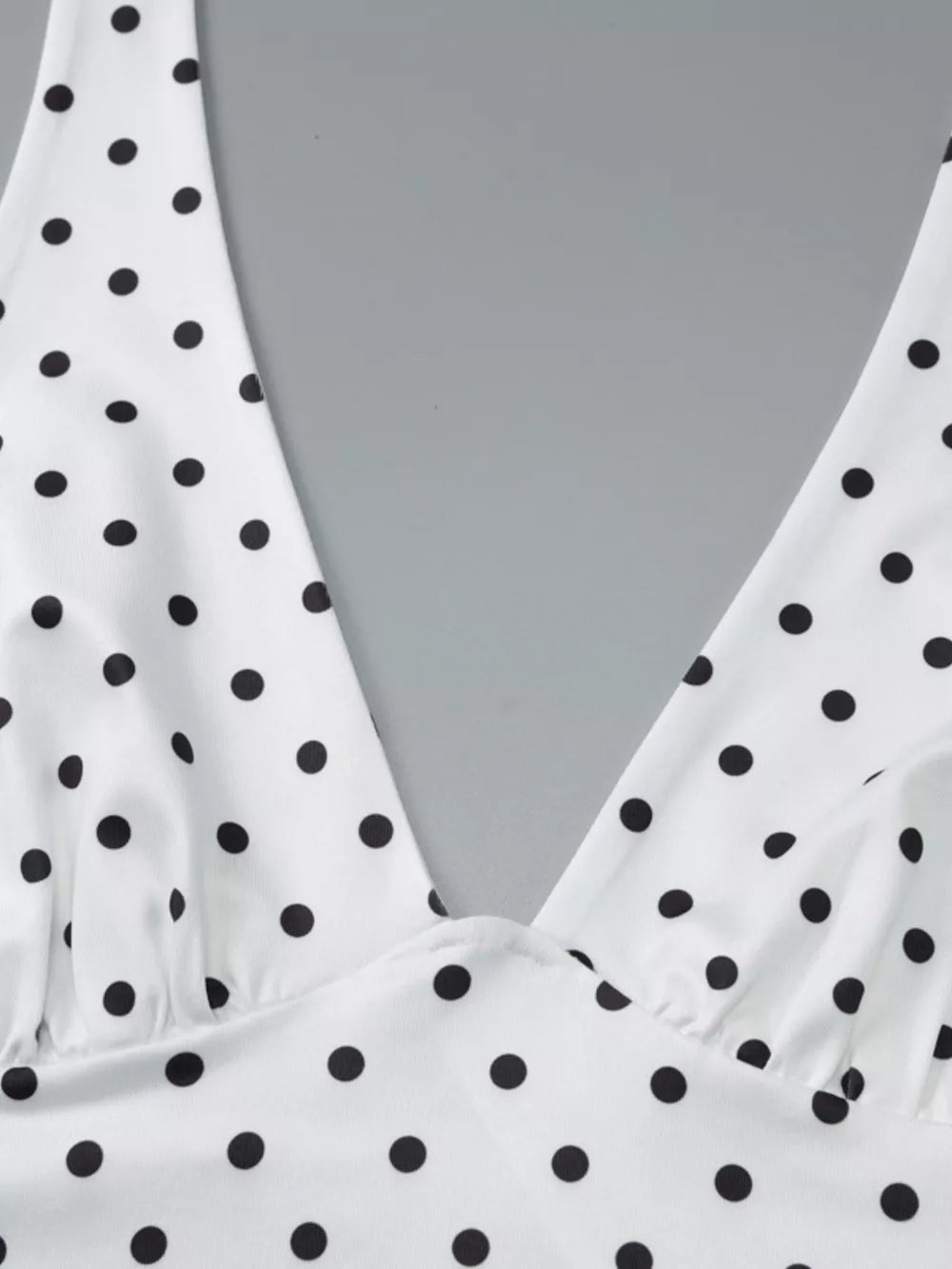 White polka dot halter cami with deep V-neck and gathered detail