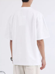 White cotton crew neck oversized t-shirt with short sleeves, shown from the back.