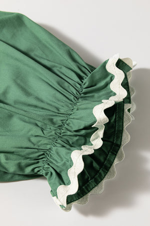 Moss green blouse with ruched puff sleeves and white scalloped trim detail.