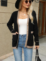 Black knit cardigan with contrast trim and gold buttons, featuring patch pockets and a relaxed fit.
