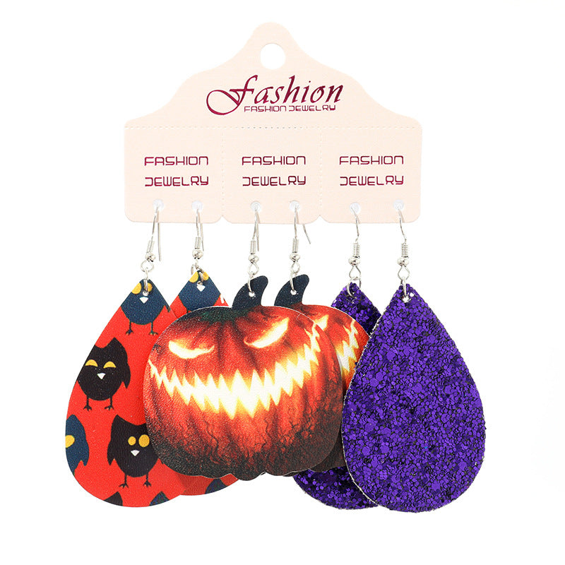 Halloween dangle earrings set with jack-o-lantern, black birds, and glitter purple teardrop designs.