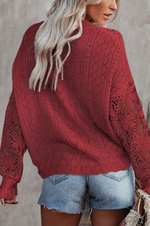 Red openwork knit sweater with lace sleeves and diamond pattern.