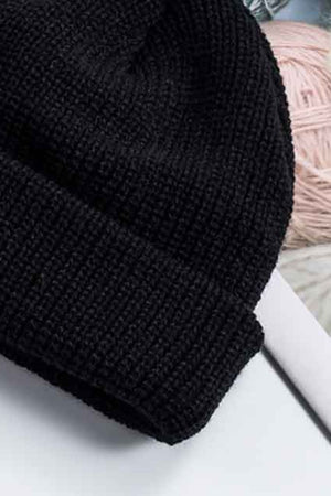 Black ribbed knit beanie with a turn-up cuff