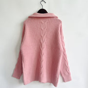 Dusty pink cable knit zip-neck sweater with ribbed texture and a prominent cable knit detail down the back.