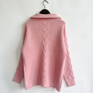 Dusty pink cable knit zip-neck sweater with ribbed texture and a prominent cable knit detail down the back.