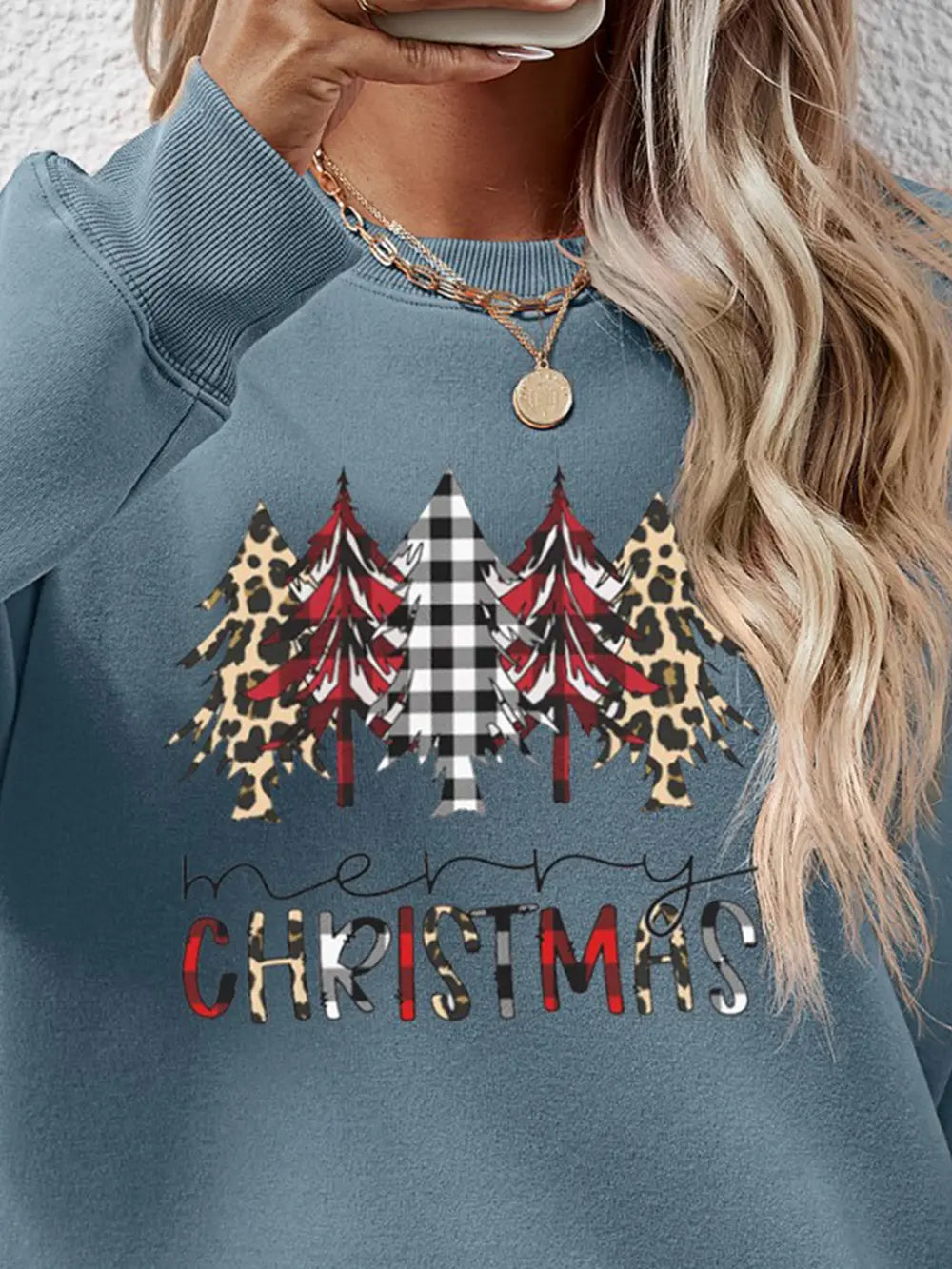 Crewneck sweatshirt in Misty Blue with Christmas trees graphic featuring buffalo plaid and leopard print.