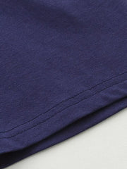 Navy blue cotton baby outfit detail showing stitching.