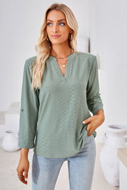 Sage textured henley blouse with rolled sleeves and a v-neck.