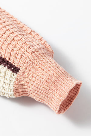 Waffle knit hoodie sleeve in pink with colorblock detail and ribbed cuff.