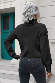 Black ribbed turtleneck sweater with scalloped hem and balloon sleeves.