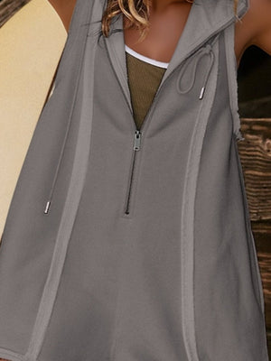 Sleeveless gray hooded romper with raw edges and a quarter zip.